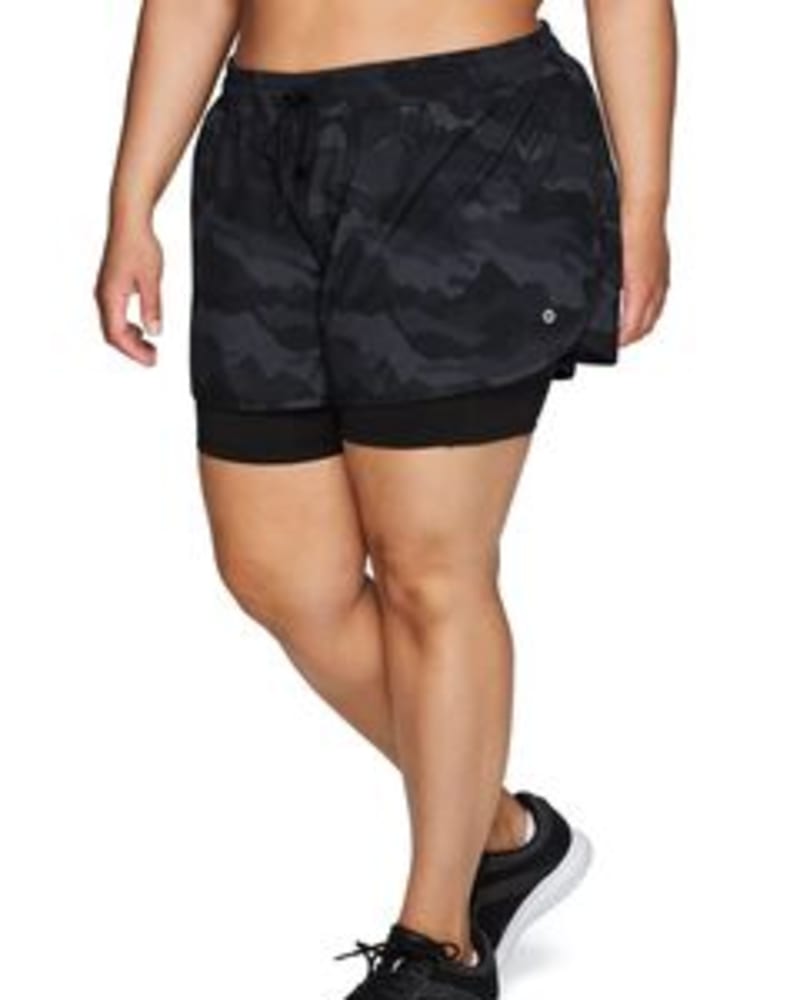 Front of a model wearing a size 1X Camo Everyday Running Short in Black by RBX Active. | dia_product_style_image_id:244581